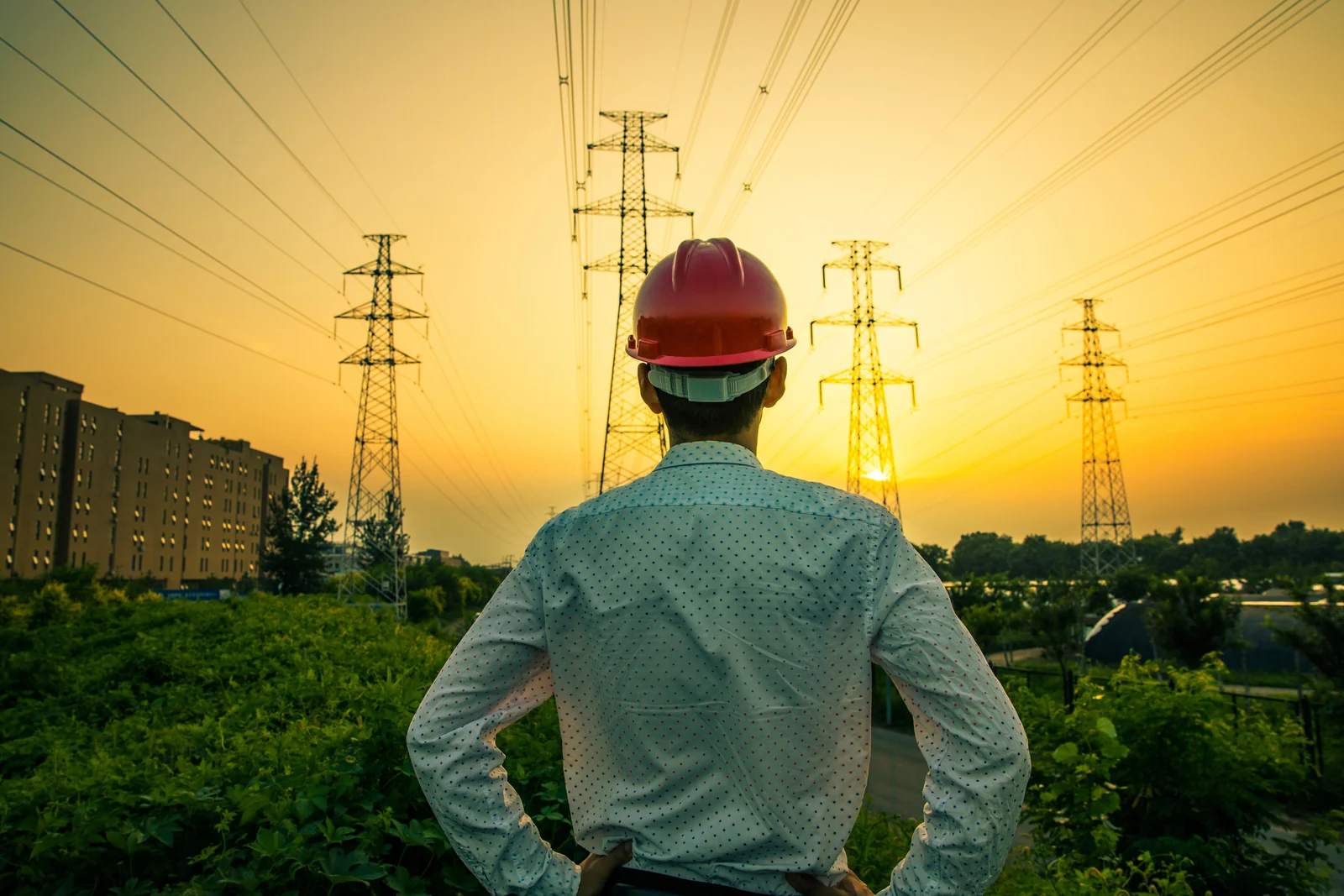 Industrial engineer reviewing power infrastructure at an outdoor site